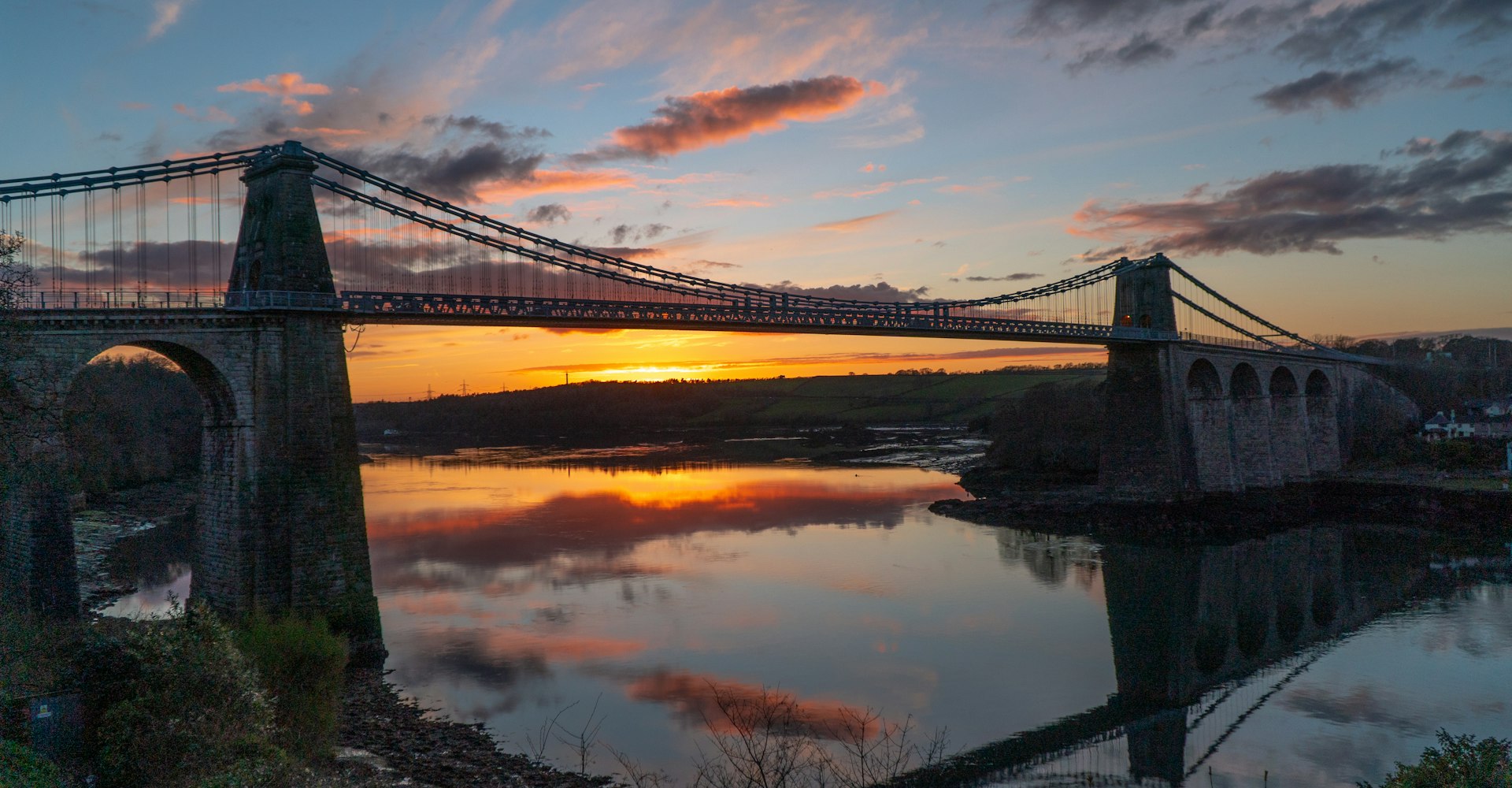 Menai Bridge over the Menai Strait at sunset, near Bangor, Gwynedd